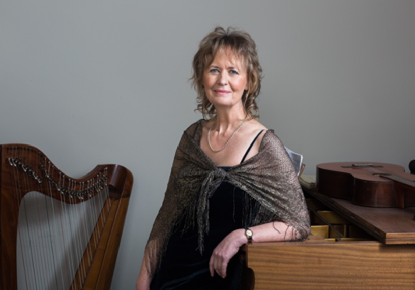 woman standing in front of piano