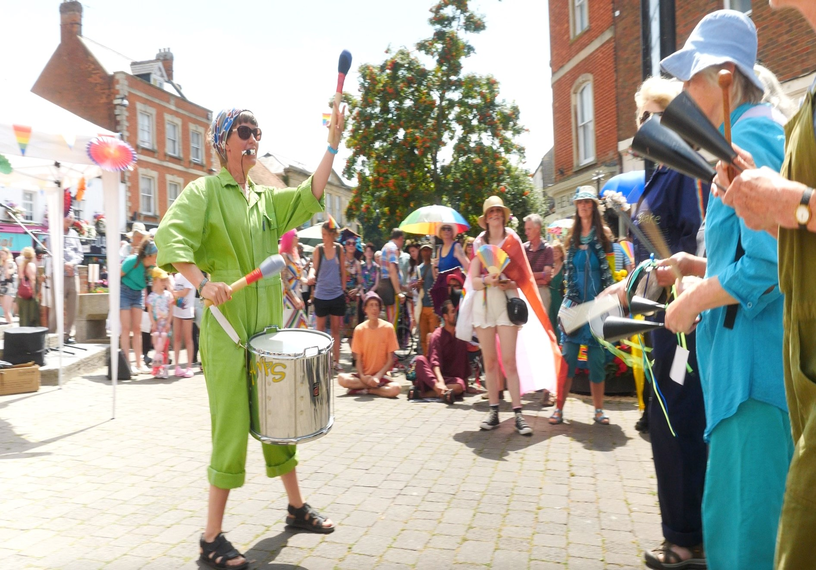 Woman drumming in front of crowd