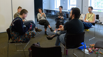 A group of young adults sitting in a circle 