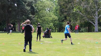 Young people playing capture the flag outside on a sunny day