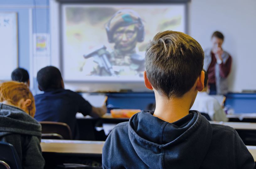 Back of child's head with soldier in background