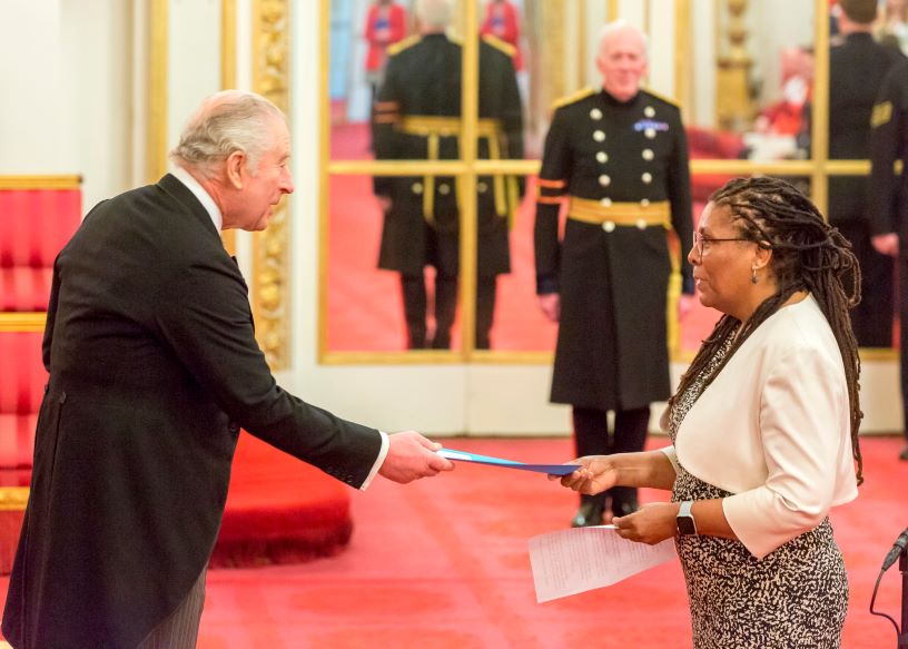 Woman handing paper to man