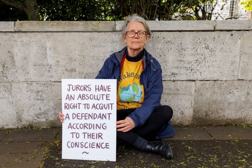 sitting woman holding placard