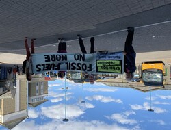 Quakers and Extinction Rebellion activists in Inverness bus station with a banner heading off to London