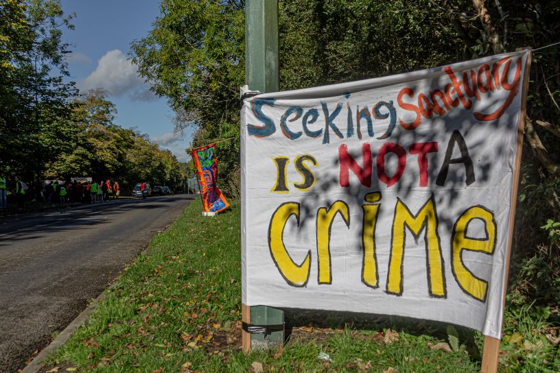 Banner reading Seeking Sanctuary is not a crime