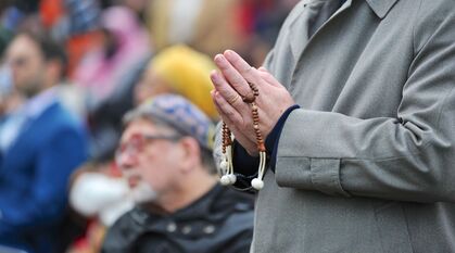 Buddhist faith leader praying at interfaith vigil at COP26