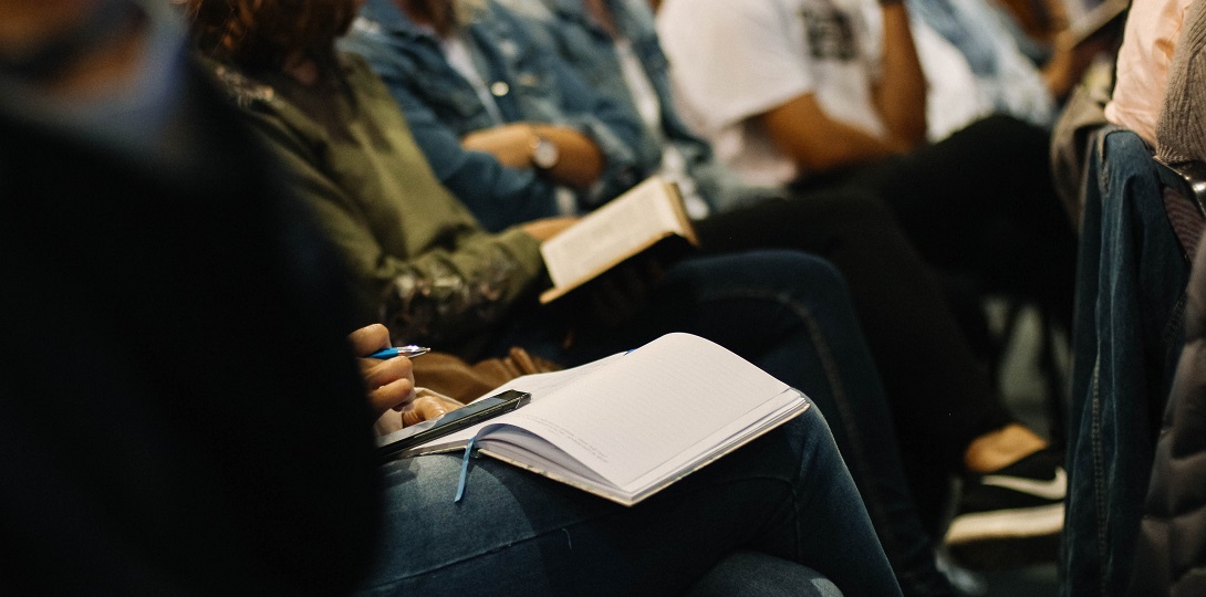 People sitting with notebooks on their laps