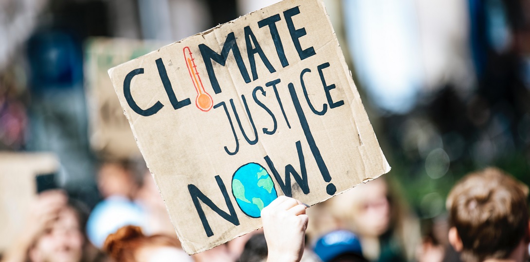 Placard with the words climate justice now