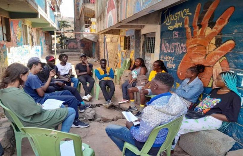 People sitting in a circle outside