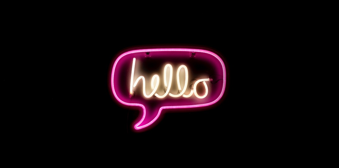 A neon light forming a speech bubble with the word hello