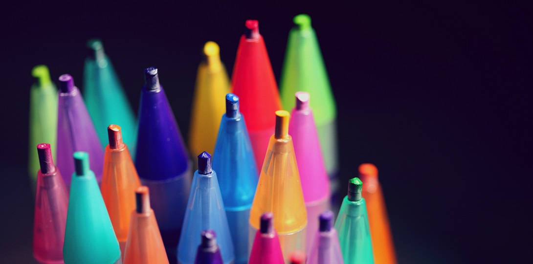 A selection of coloured pencils pointing upwards