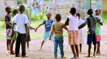 Children in Kenya holding hands in a circle