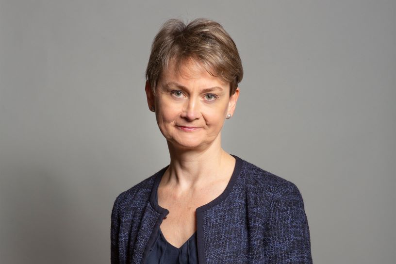 Headshot of white woman against grey background