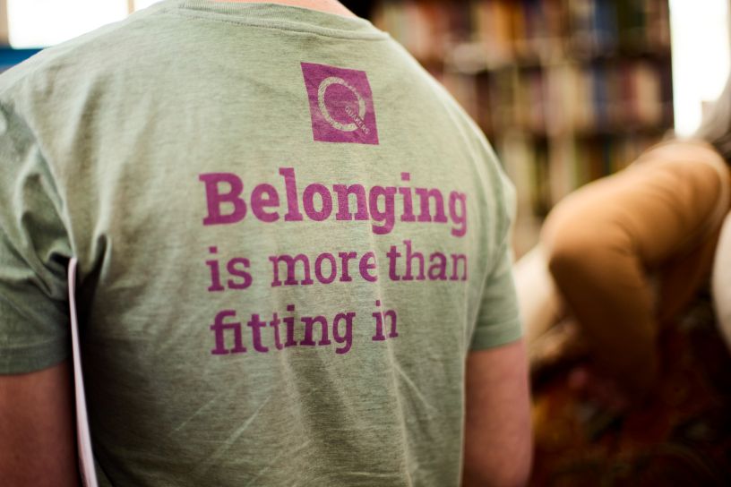 Man's back with t-shirt logo 'Belonging is more than fitting in'