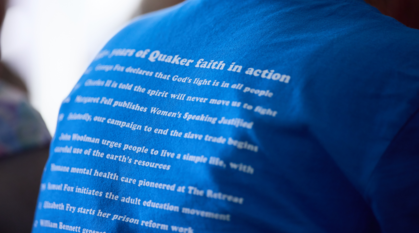 Close-up of the faith in action timeline on the back of a Quakers for Peace T-shirt that someone is wearing