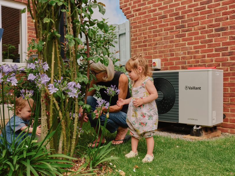Small child in garden near heat pump