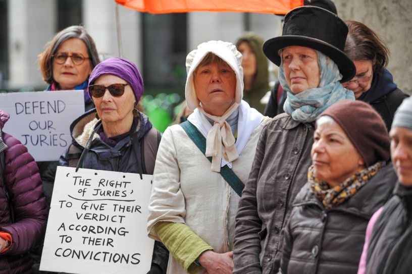 People in bonnets and holding placards